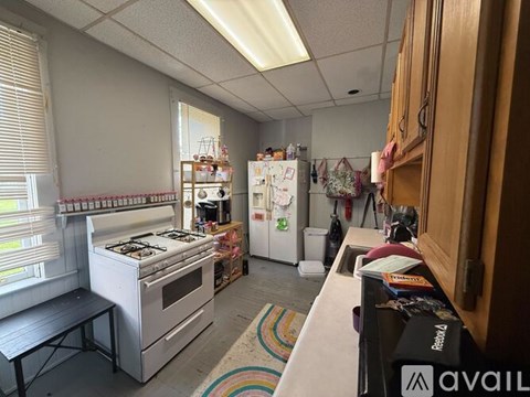 A kitchen with a white stove and a white refrigerator.