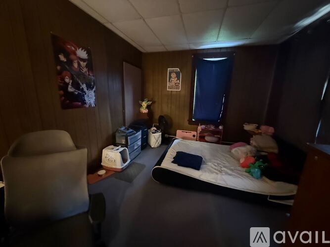 A room with a bed, chair, and toaster.