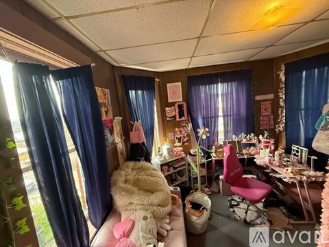 A room with a bed, desk, and chair.