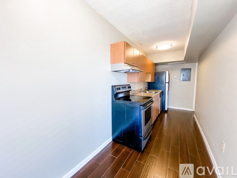 A kitchen with a blue oven and wooden floors.