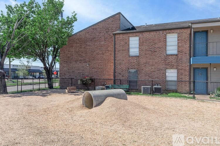 A brick building with a playground in front.