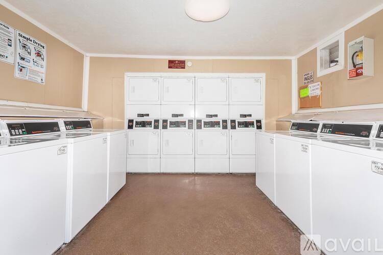 A laundromat with washers and dryers lined up.