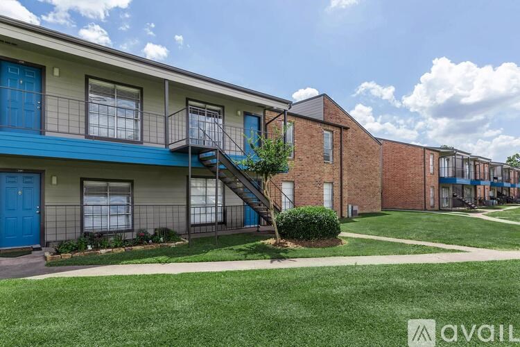 A row of houses with blue doors and windows.