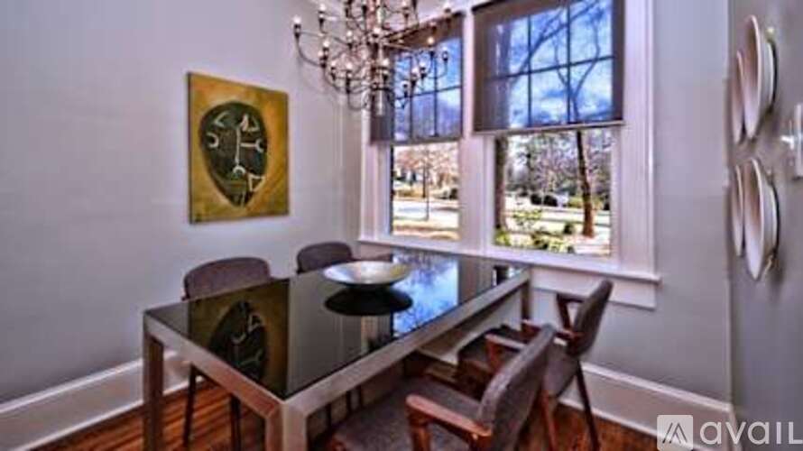 A dining room with a glass table and chairs.