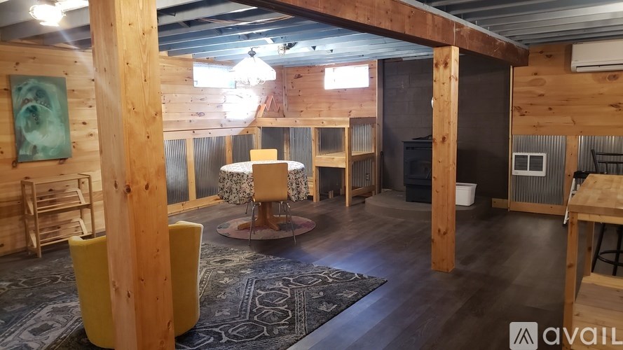 A room with wooden walls and a rug on the floor.