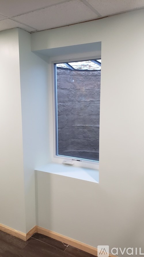 A window in a room with a view of a tree.