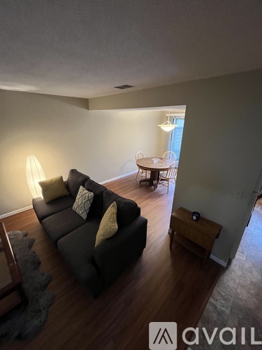 A living room with a grey couch and a wooden coffee table.
