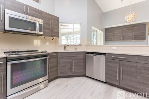 A modern kitchen with a stainless steel oven and microwave.
