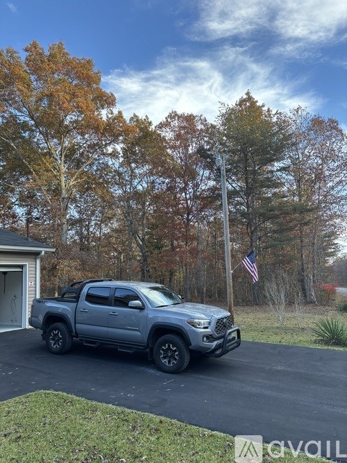 A grey truck is parked in a driveway.