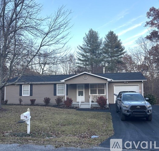 A house with a car parked in front of it.