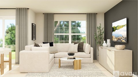 A modern living room with a white sofa set and a large window.