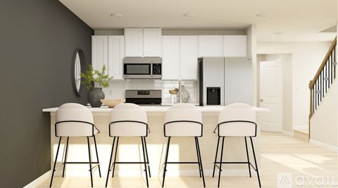 A modern kitchen with white cabinets and a bar area with four stools.