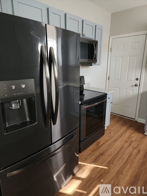 A black stainless steel refrigerator with a water and ice dispenser in the freezer compartment.