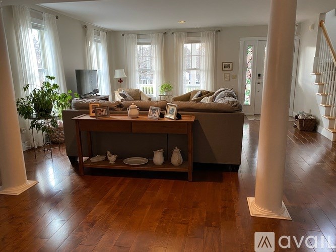 A living room with a brown couch and a wooden coffee table.