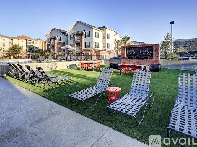 A row of lawn chairs are lined up on a concrete patio.