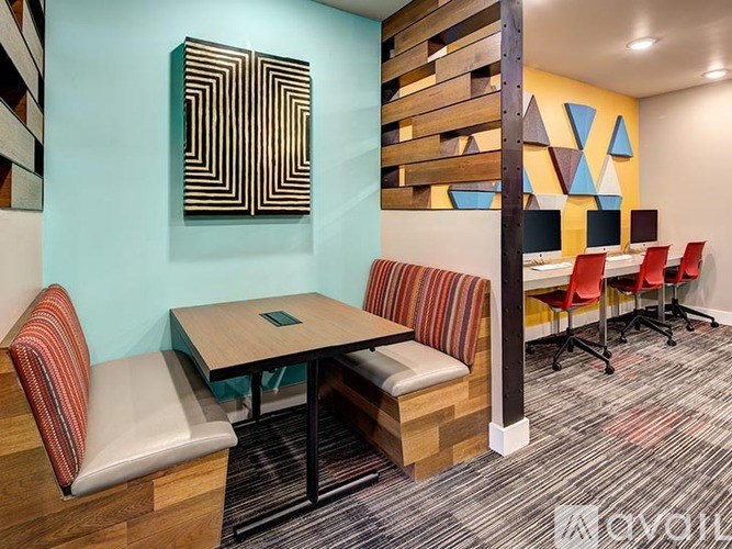 A room with a blue wall and a wooden panel with a painting on it.