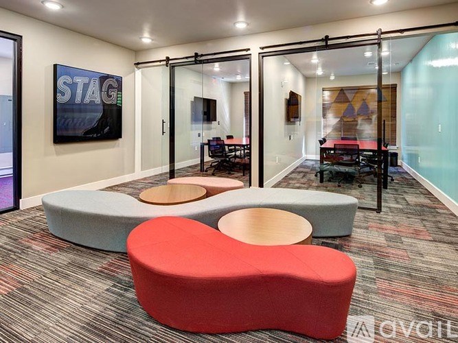 A modern office space with a glass wall and a sign that says "STAG".