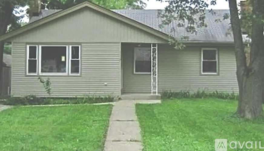 A house with a grey roof and a green lawn.