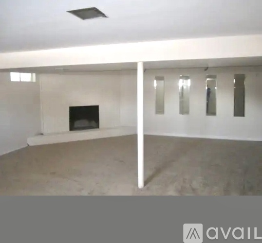 A living room with a fireplace and a white floor.