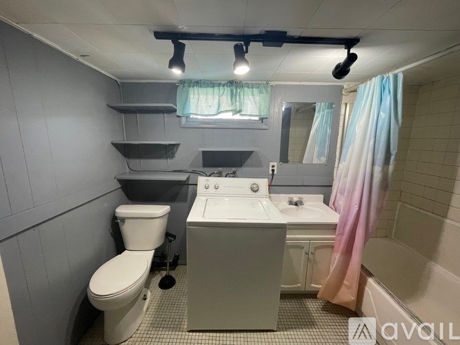 A bathroom with a toilet, sink, and bathtub.