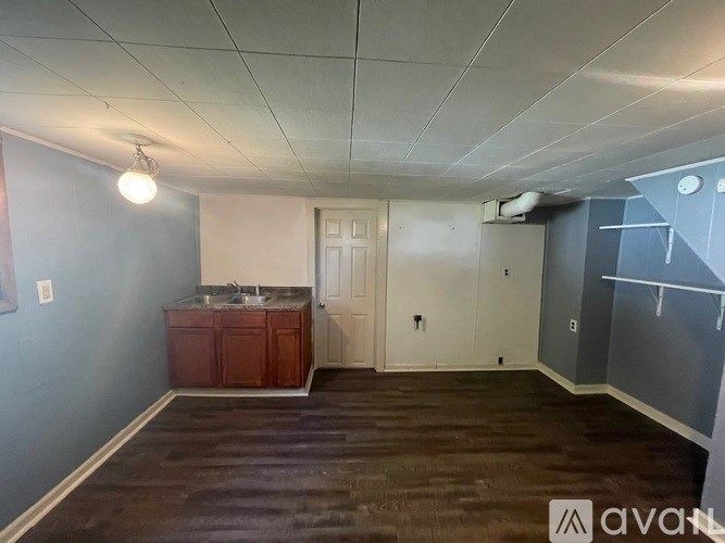A room with a sink and a cabinet in it.