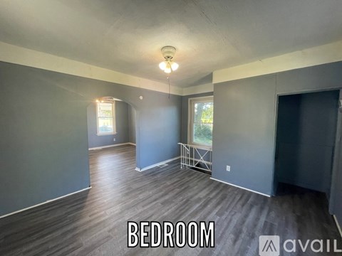 A spacious bedroom with a large bed and a window.