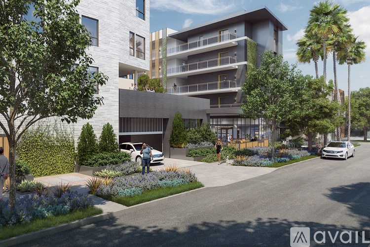 A modern apartment complex with a car parked in front.