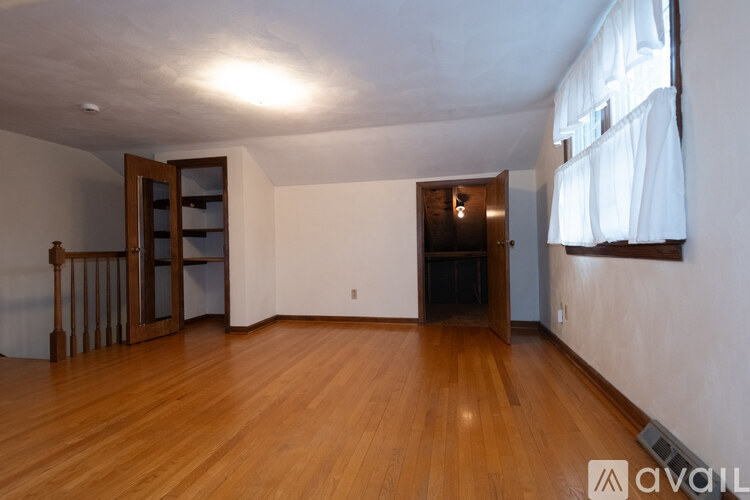 A room with wooden floors and a large open space.