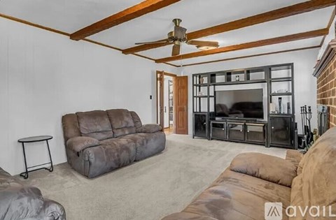 A living room with a grey sofa and a black entertainment center.