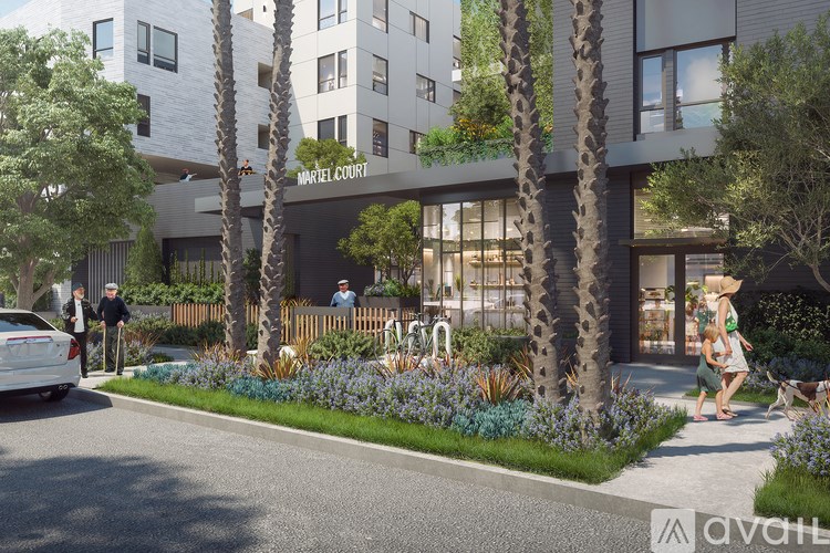 A modern hotel with a palm tree in front.