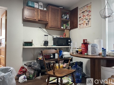 A kitchen with a table and chairs in the middle of it.