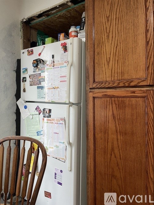 A white fridge with many papers attached to it.