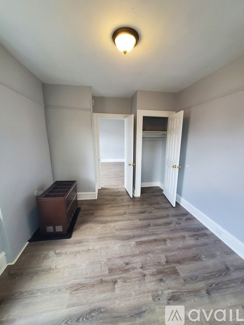 A room with a wooden floor and a light on the ceiling.