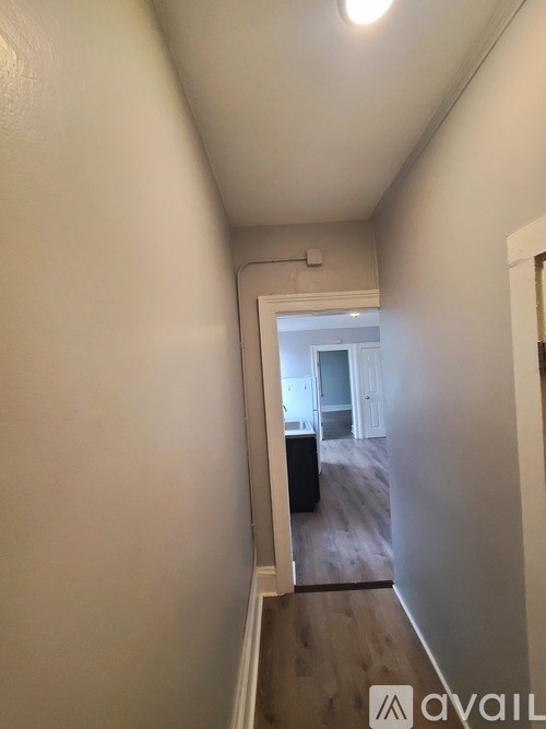 A hallway with a door at the end.