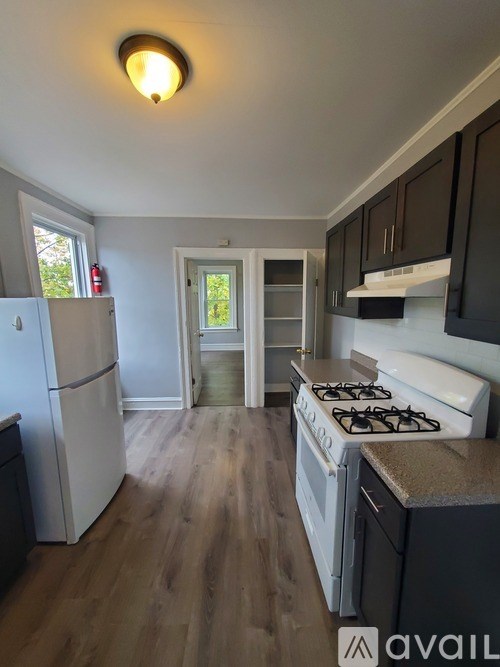 A kitchen with a white fridge and a white stove top.