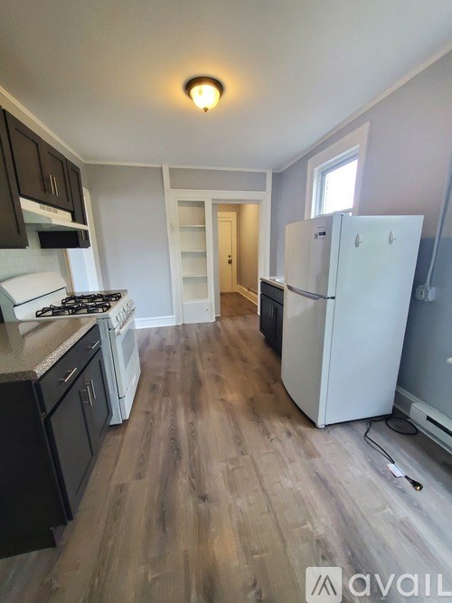 A kitchen with a white fridge and a stove top oven.