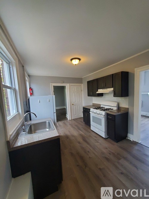 A kitchen with a sink, stove, and oven.