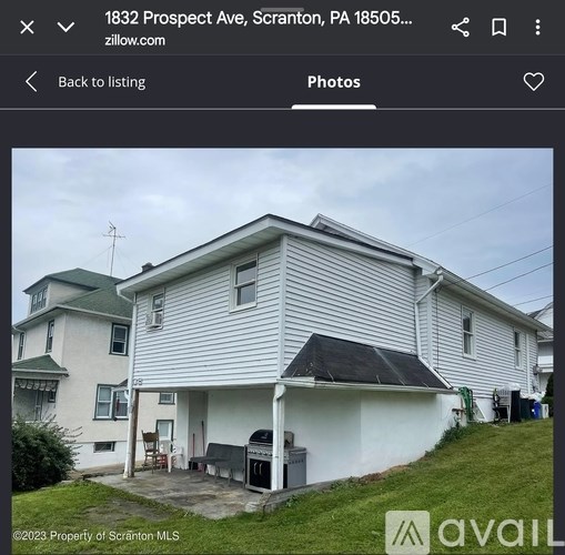 A two-story house with a garage is for sale.