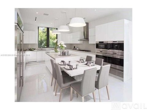 A modern kitchen with a dining table set for four.