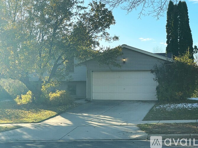 A house with a garage is for sale.