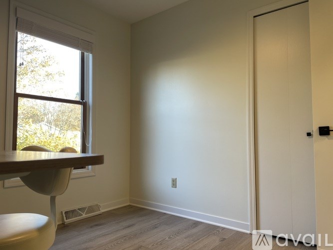 A room with a window and a door.