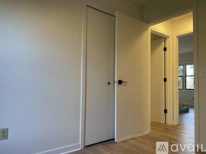 A white door is closed with a black handle.