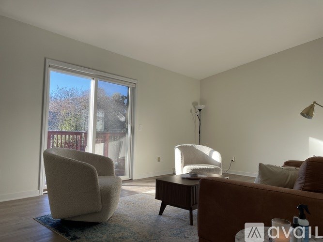 A living room with a couch, chair, and lamp.