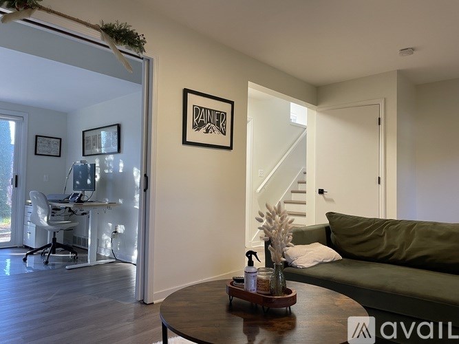 A living room with a couch, a coffee table, and a framed picture on the wall.