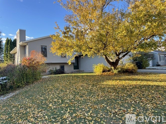 A house with a tree in front of it.