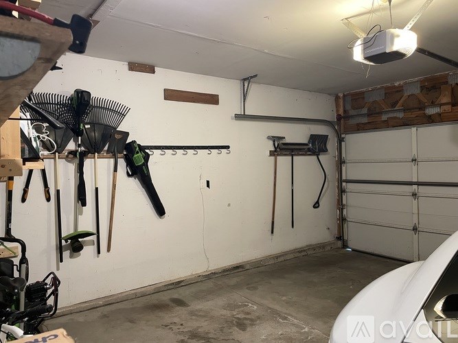A garage with a white wall and a white garage door.