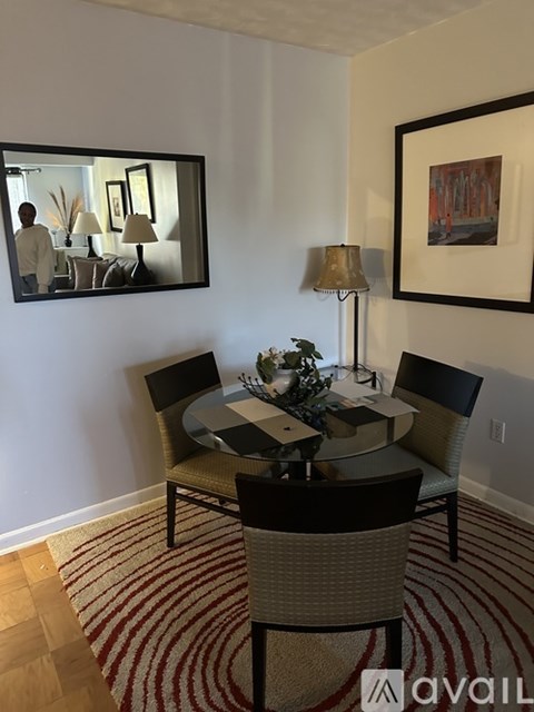 A dining room with a round table and chairs.