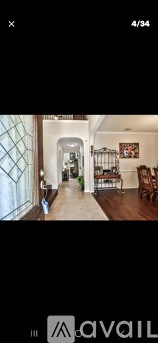 A hallway with a dog and a cat sitting on the floor.