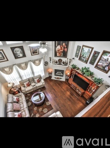 A living room with a couch, a coffee table, a TV, and a fireplace.