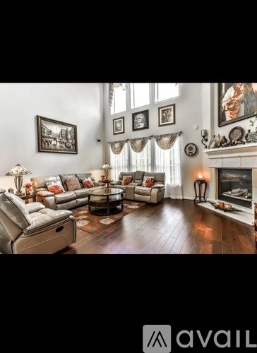 A living room with a fireplace and a large sofa.